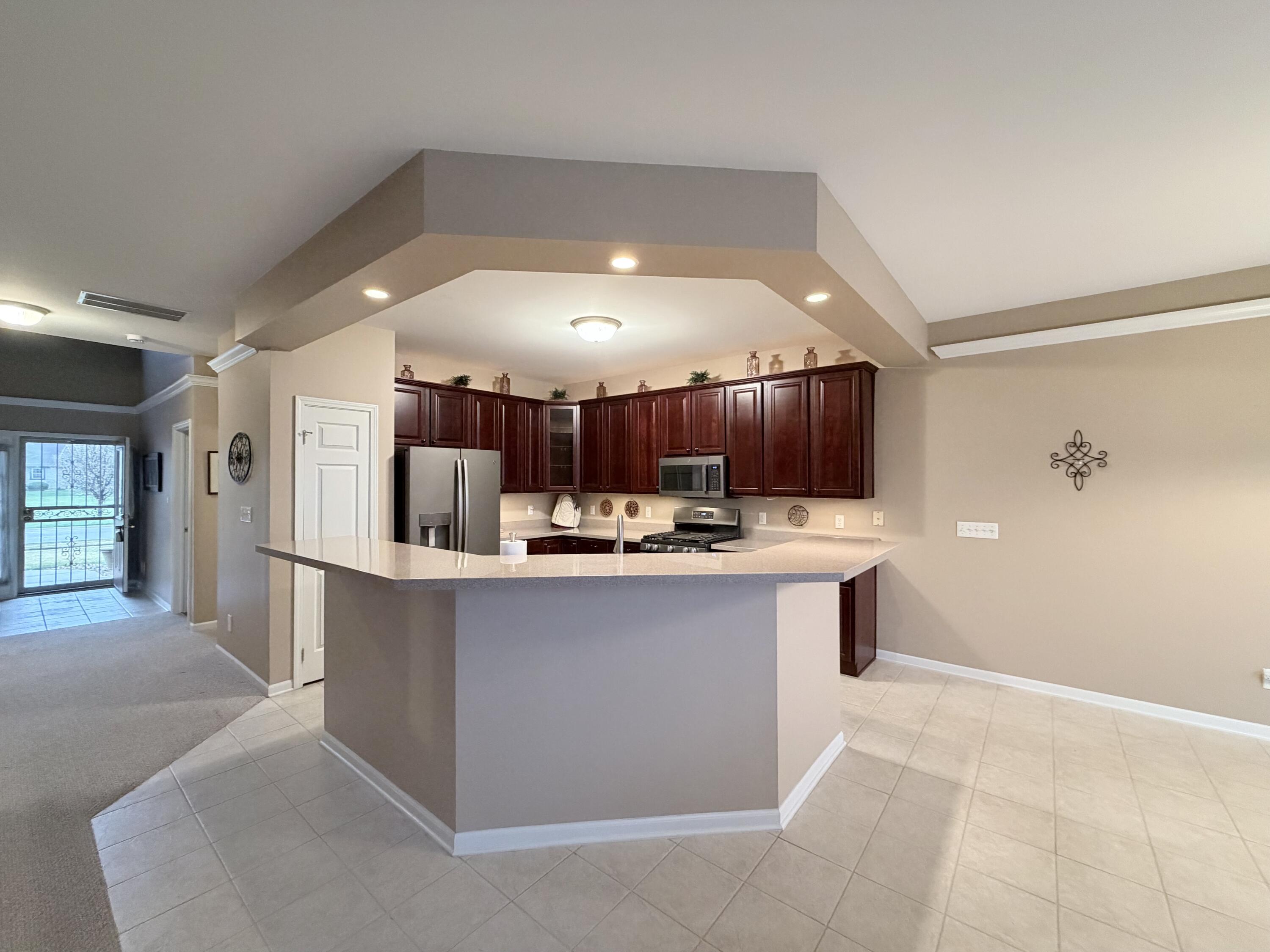 11677 Maryland Street Crown Point, IN 46307 - Photo 18 of 31 a view of kitchen with kitchen island wooden floor center island and stainless steel appliances
