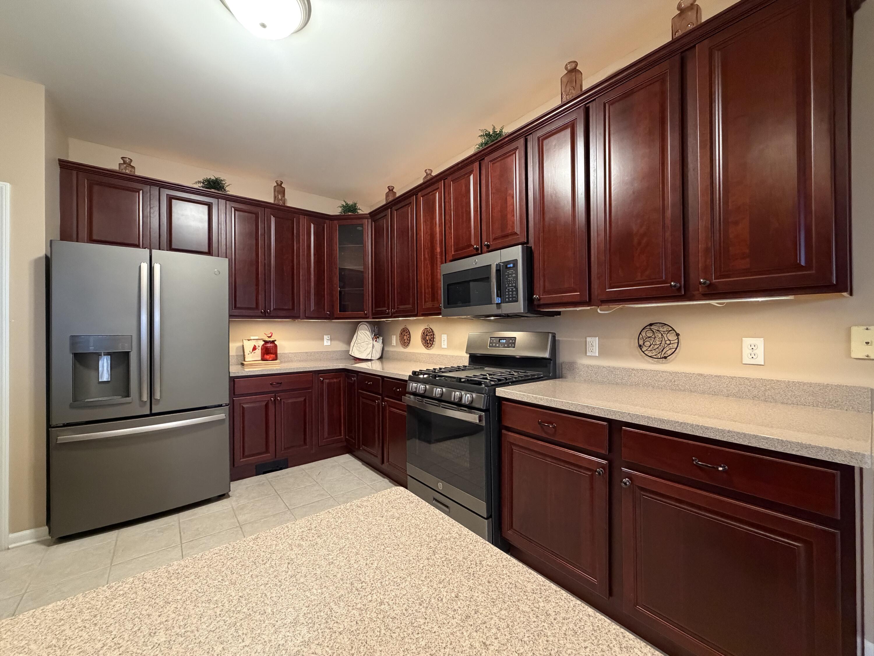 11677 Maryland Street Crown Point, IN 46307 - Photo 20 of 31 a kitchen with granite countertop stainless steel appliances and wooden cabinets