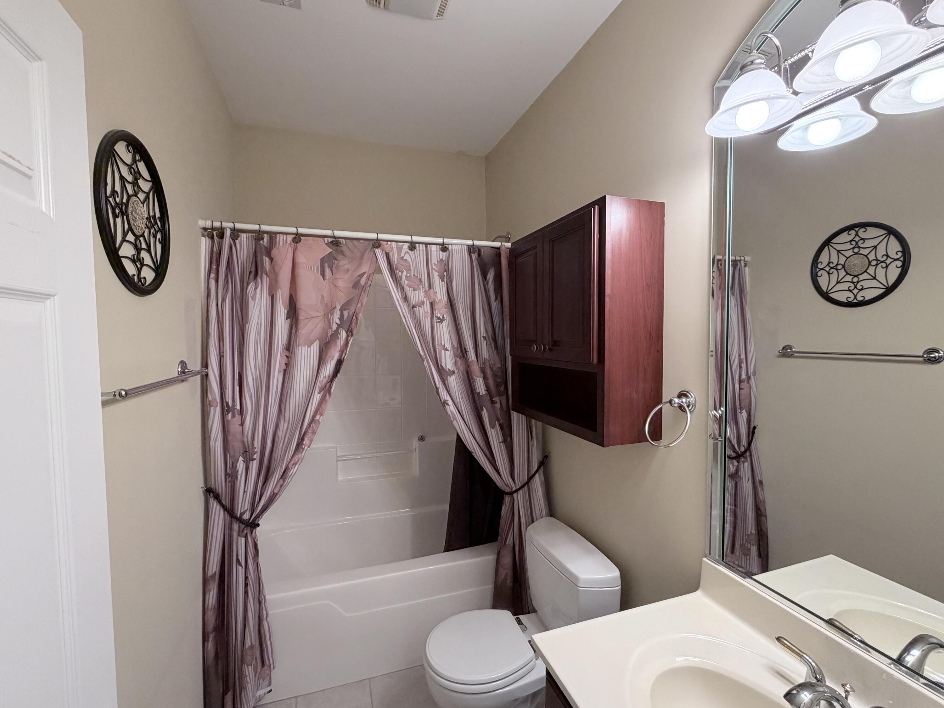 11677 Maryland Street Crown Point, IN 46307 - Photo 25 of 31 a bathroom with a toilet a sink and a shower