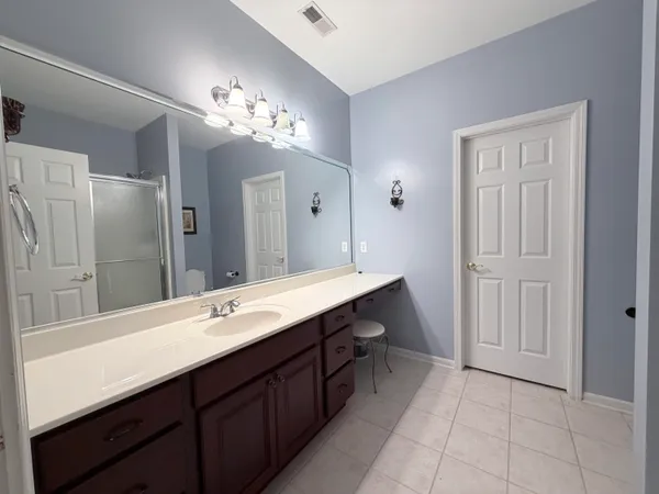 a bathroom with a double vanity sink and a mirror