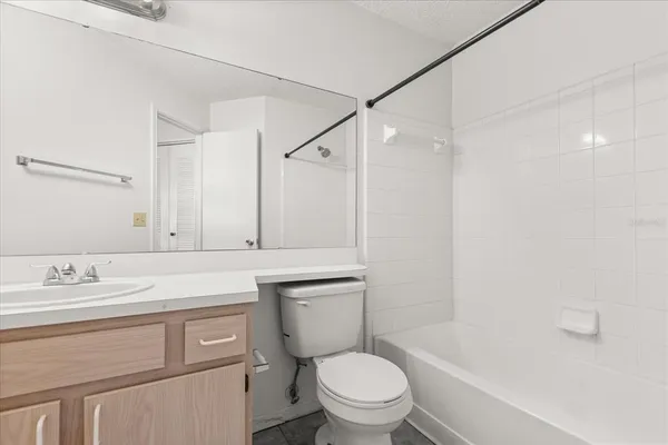a bathroom with a sink toilet vanity and shower