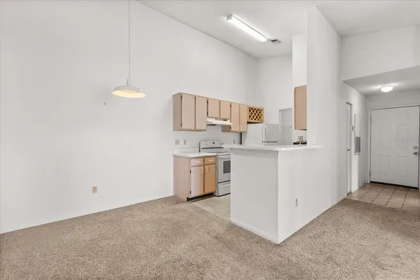a utility room with cabinets washer and dryer