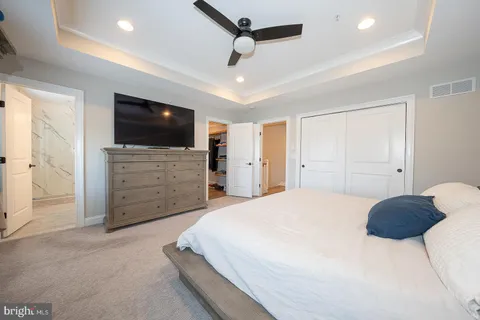 a bedroom with a bed a television and dresser