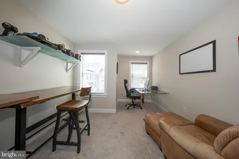 a bed sitting in a bedroom next to a window