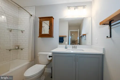 a bathroom with a shower a toilet and a bathtub