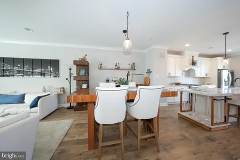 a view of kitchen with cabinets table and chairs
