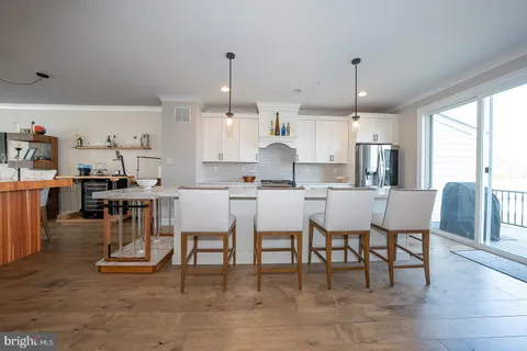 a large kitchen with a table and chairs