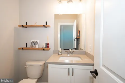 a bathroom with a toilet a sink and mirror
