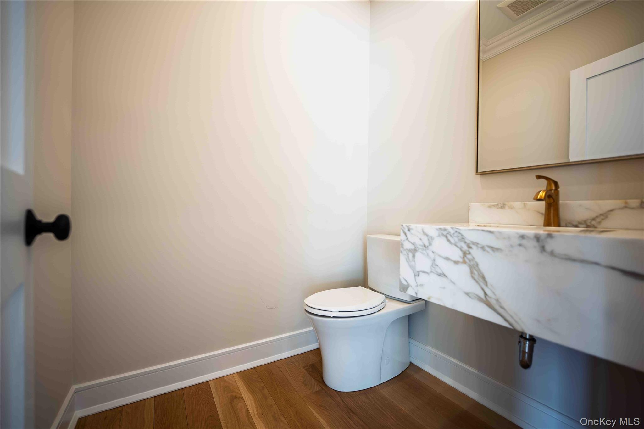106 Cove Road Asharoken, NY 11768 - Photo 19 of 46 Half bathroom with vanity and dark wood-style floors