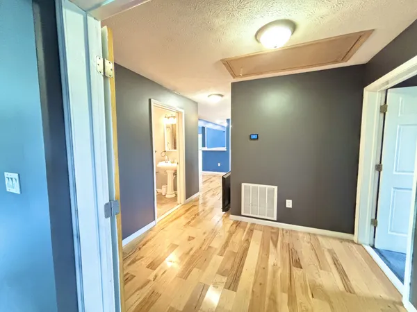 a living room with furniture a flat screen tv and a chandelier