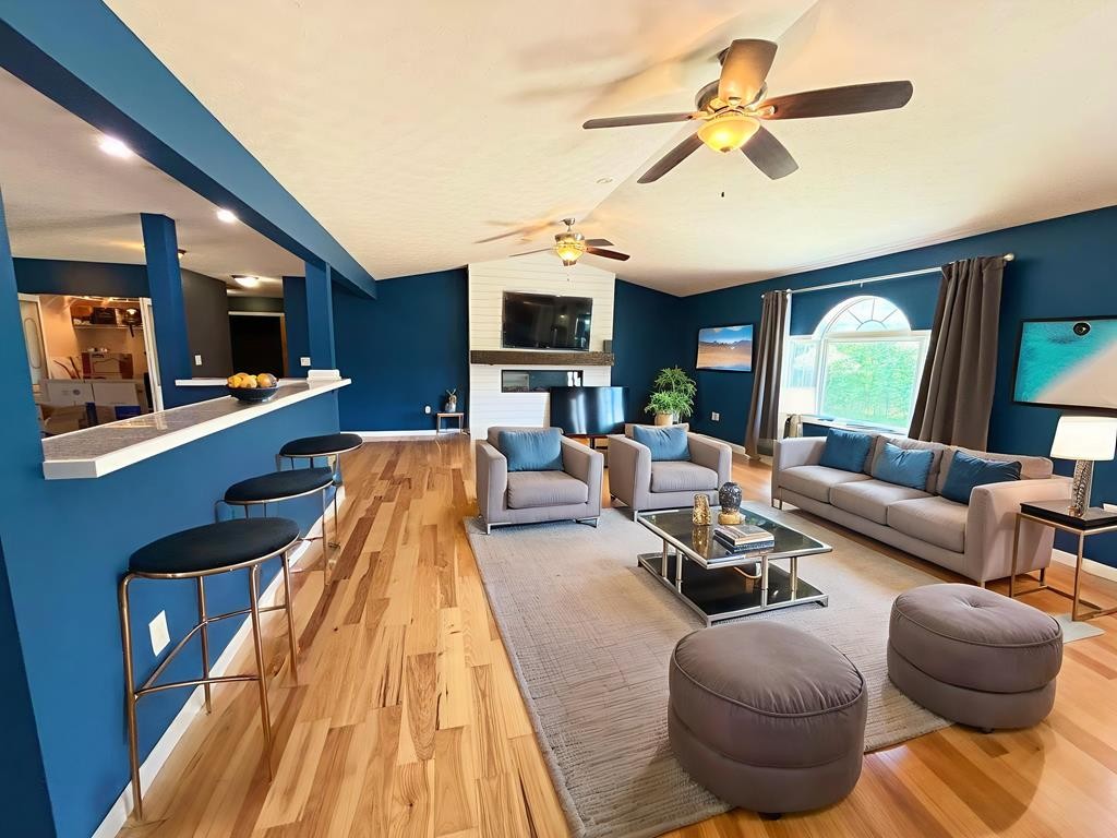 545 Adams Store Poole Mill Road Crofton, KY 42217 - Photo 26 of 48 a living room with furniture a flat screen tv and a chandelier