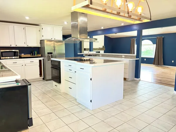 a kitchen with stainless steel appliances a stove a refrigerator and a sink