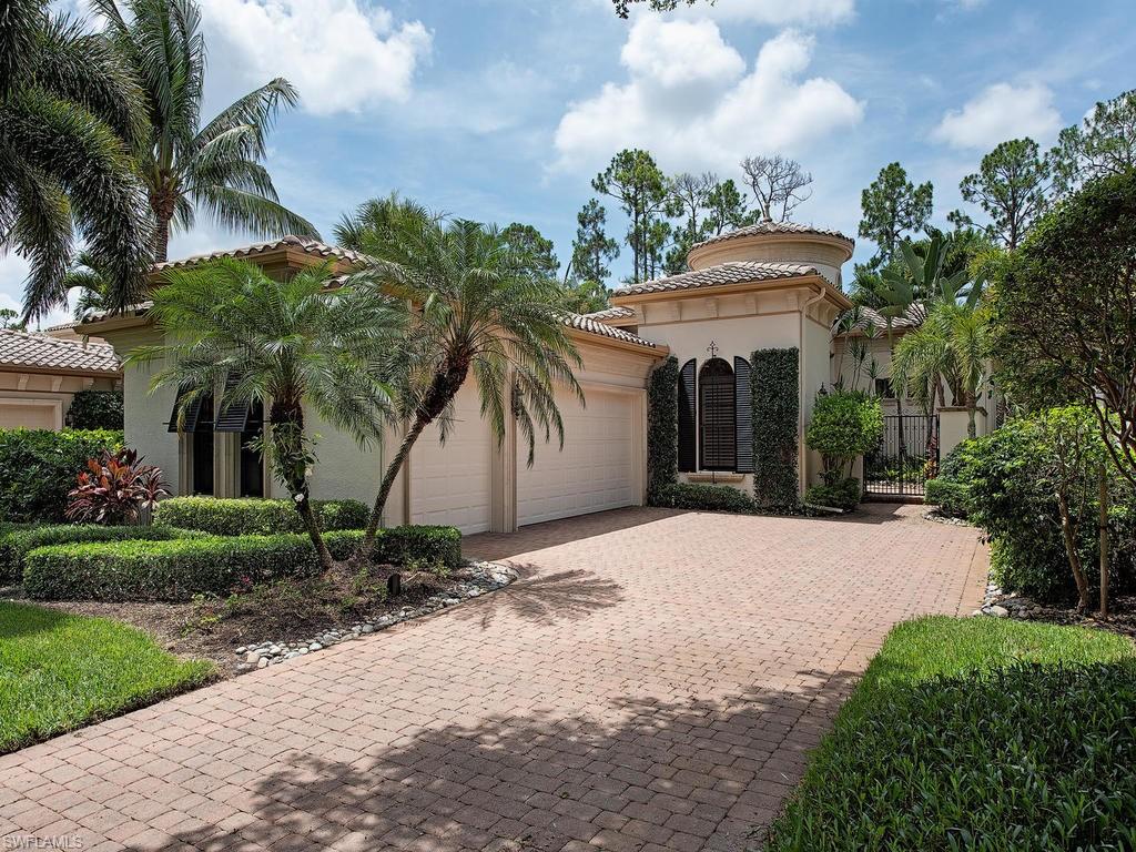 18081 Lagos Way Naples, FL 34110 - Photo 1 of 23 a front view of a house with a yard and garage
