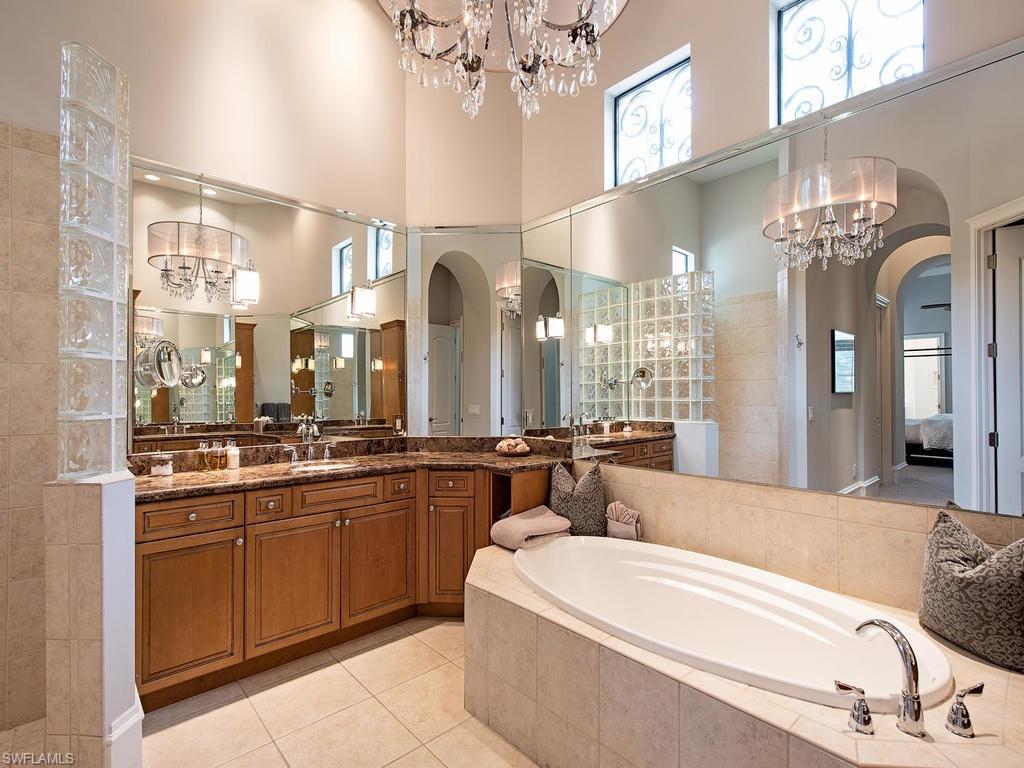 18081 Lagos Way Naples, FL 34110 - Photo 11 of 23 a large spacious bathroom with a large tub and sink