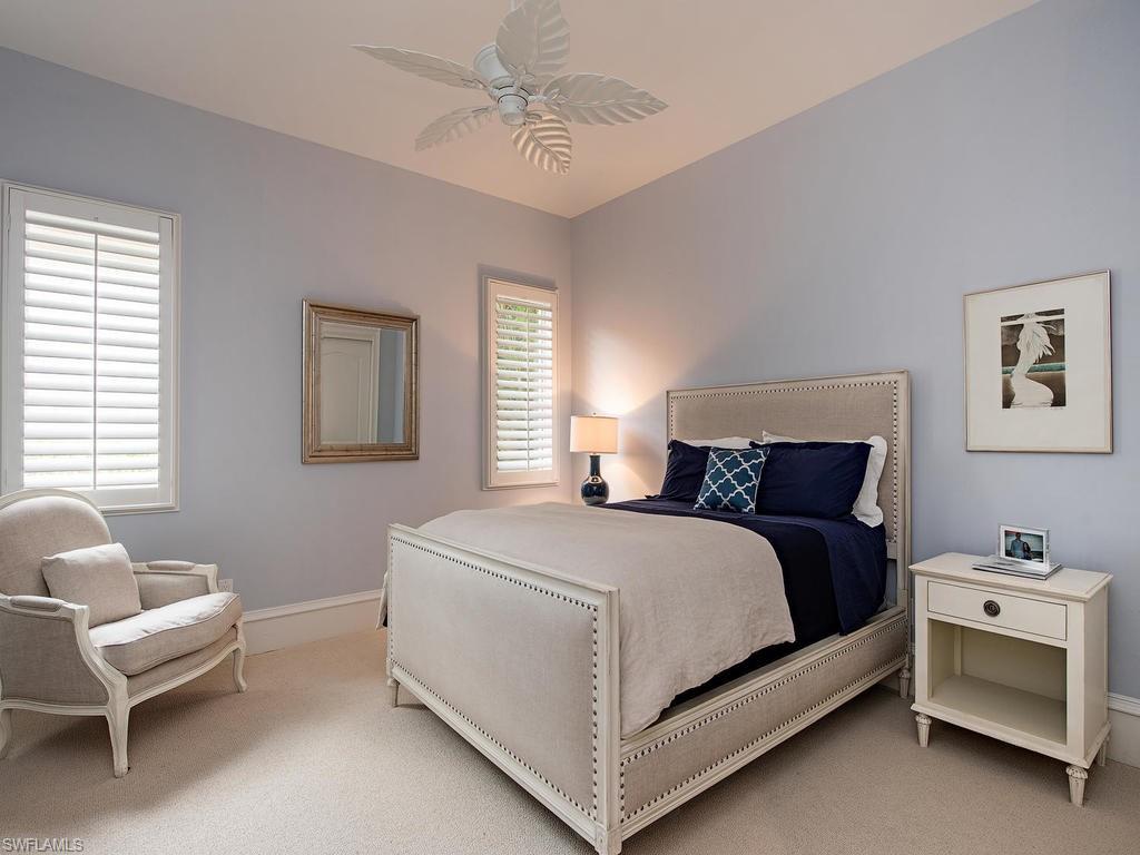 18081 Lagos Way Naples, FL 34110 - Photo 13 of 23 a bedroom with a bed and a couch