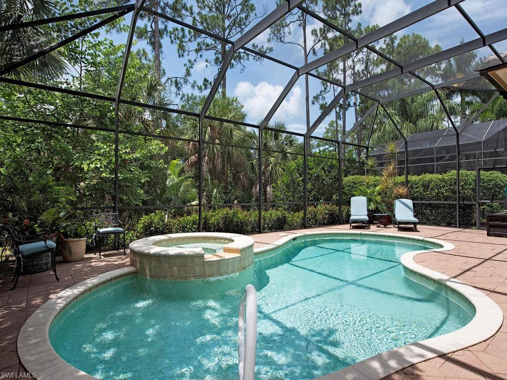 18081 Lagos Way Naples, FL 34110 - Photo 15 of 23 a view of a swimming pool with a patio