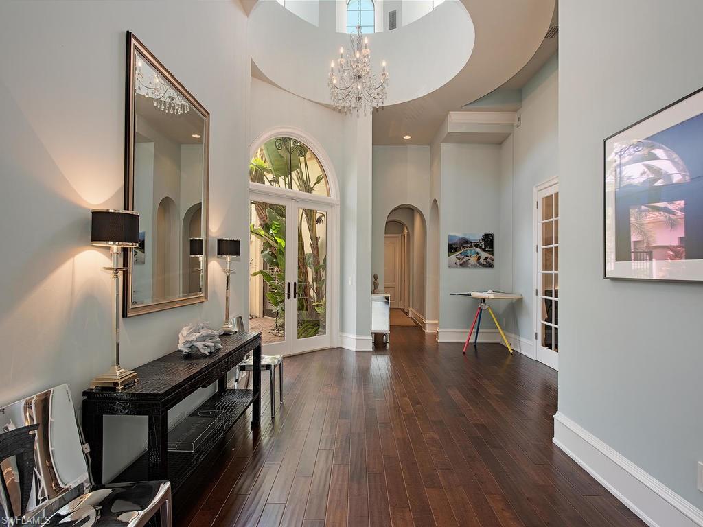 18081 Lagos Way Naples, FL 34110 - Photo 2 of 23 a view of a livingroom with furniture front door and wooden floor