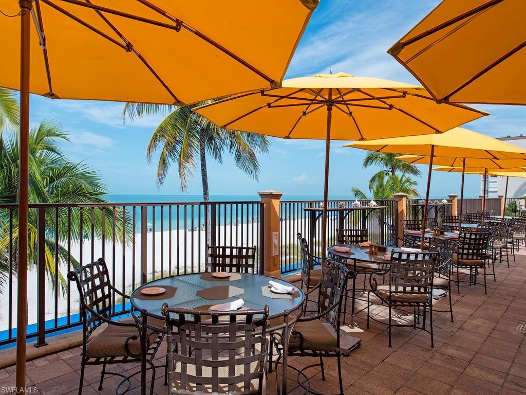 18081 Lagos Way Naples, FL 34110 - Photo 22 of 23 a patio with a patio table and chairs
