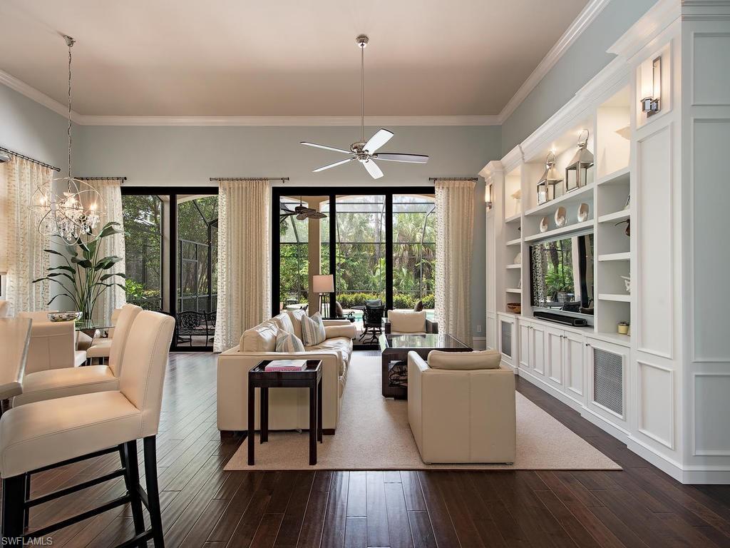 18081 Lagos Way Naples, FL 34110 - Photo 4 of 23 a living room with furniture wooden floor and a large window