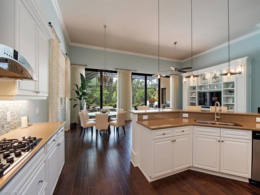 18081 Lagos Way Naples, FL 34110 - Photo 6 of 23 a kitchen with a sink stove and wooden floor