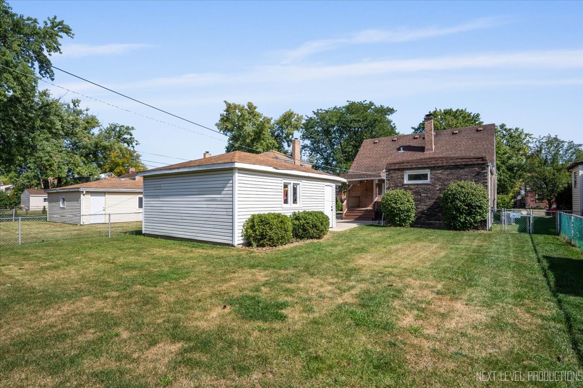 2440 South 20th Avenue Broadview, IL 60155 - Photo 22 of 24 a view of a yard in front of a house with plants and large tree