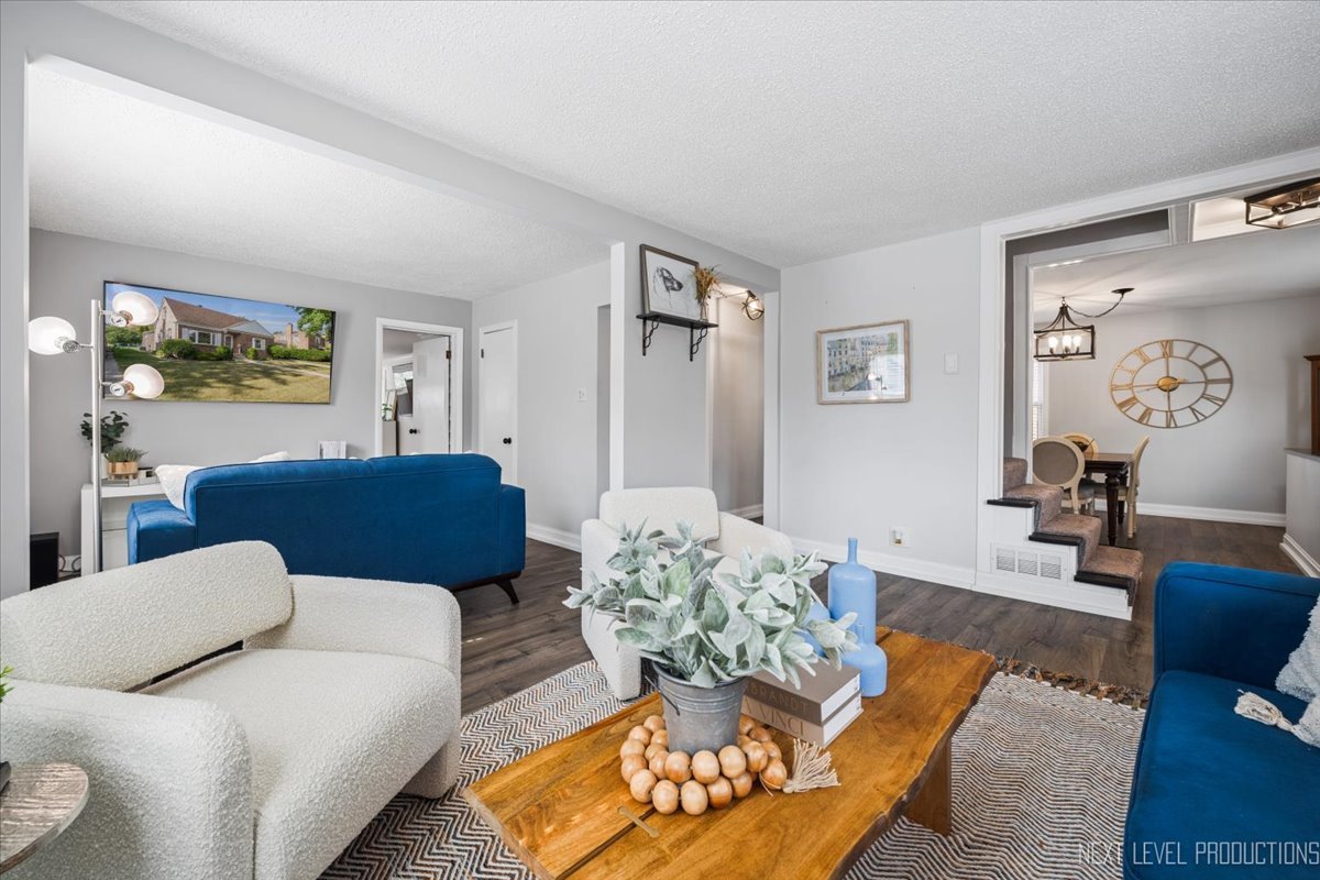 2440 South 20th Avenue Broadview, IL 60155 - Photo 4 of 24 a living room with furniture and painting on the wall