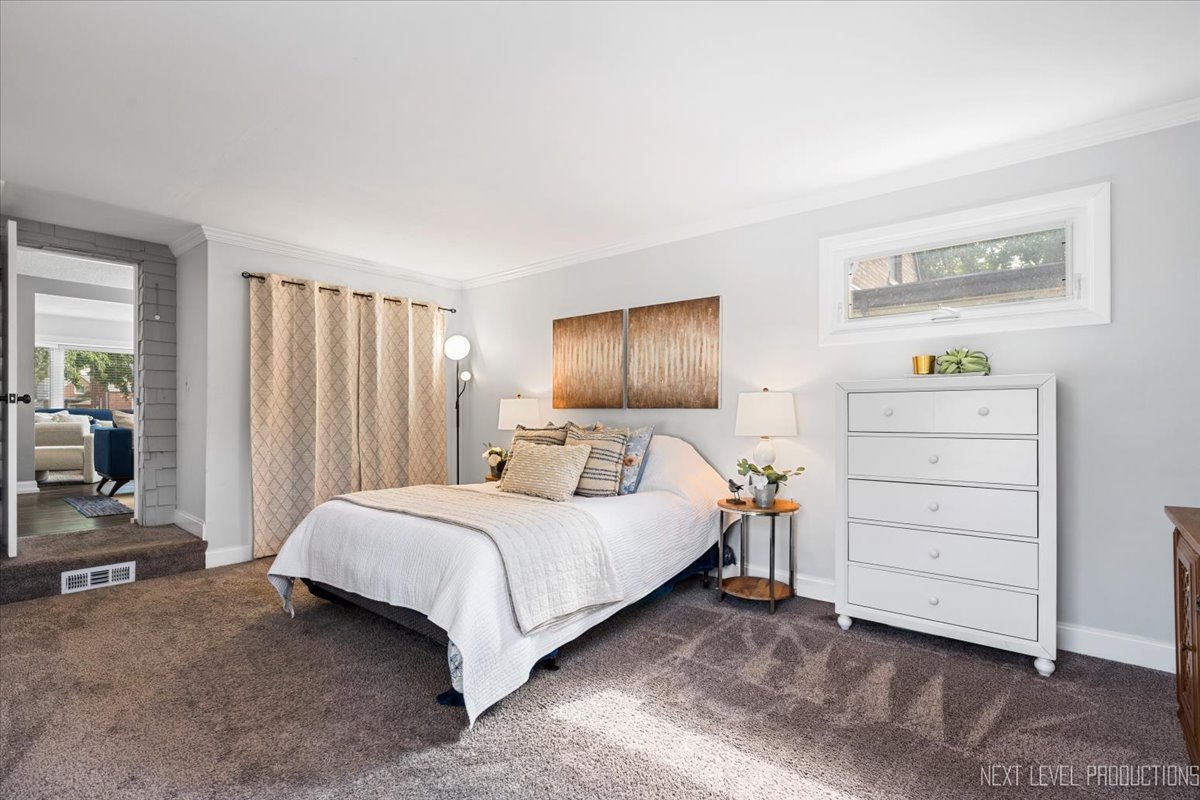 2440 South 20th Avenue Broadview, IL 60155 - Photo 7 of 24 a bedroom with a bed and a cabinets
