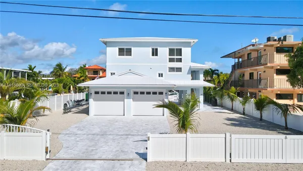 a view of a patio with table and chairs and potted plants