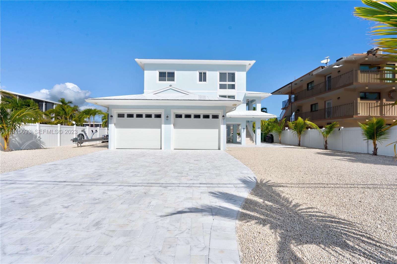 48 Andros Road Key Largo, FL 33037 - Photo 17 of 60 a front view of a house with a yard