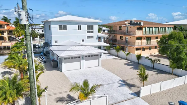 a view of a swimming pool with a lawn chairs and potted plants
