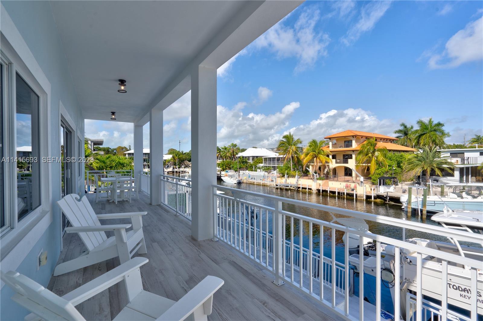 48 Andros Road Key Largo, FL 33037 - Photo 30 of 60 a view of a balcony with chairs