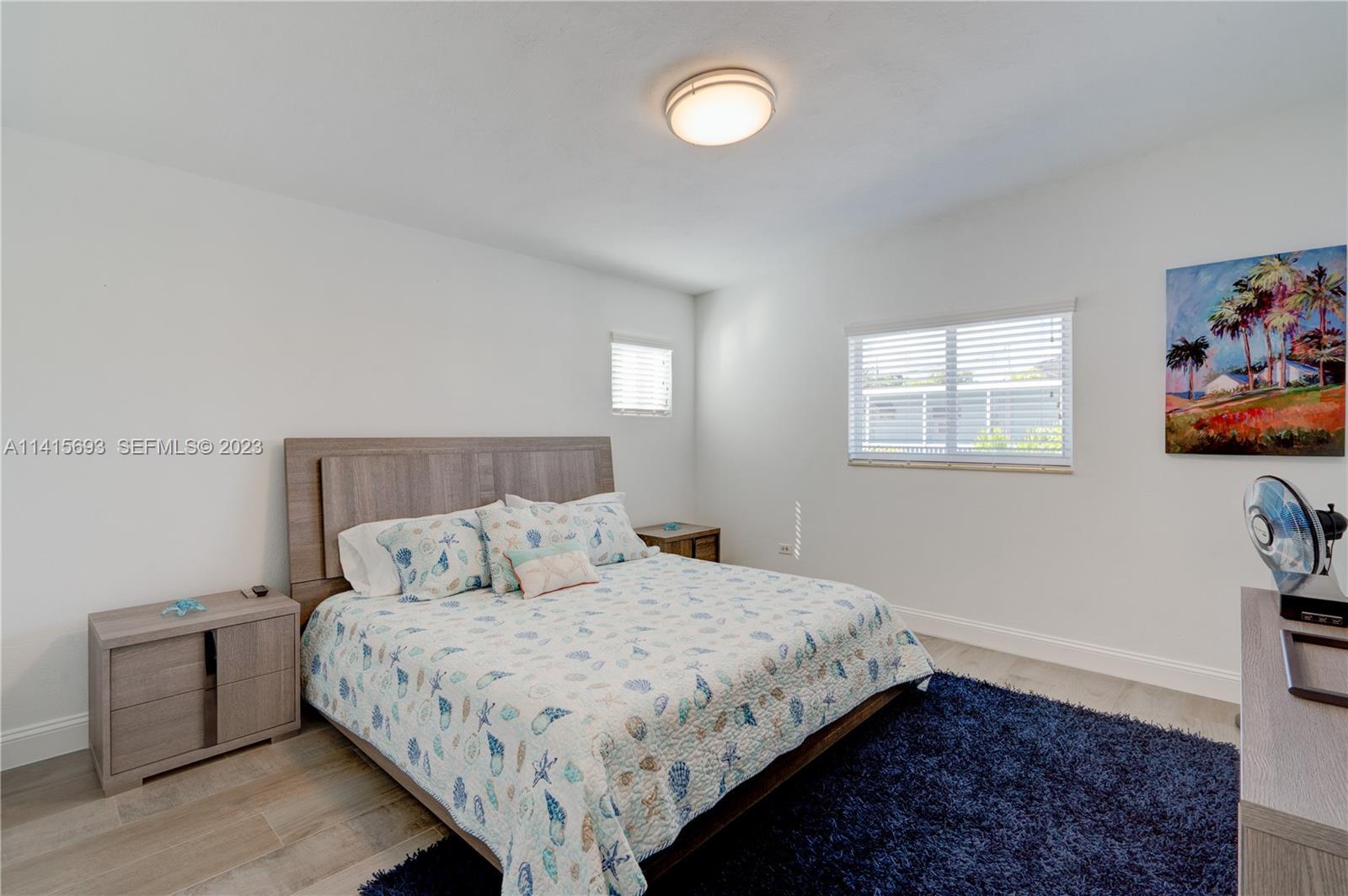 48 Andros Road Key Largo, FL 33037 - Photo 35 of 60 a bedroom with a bed and painting on the wall