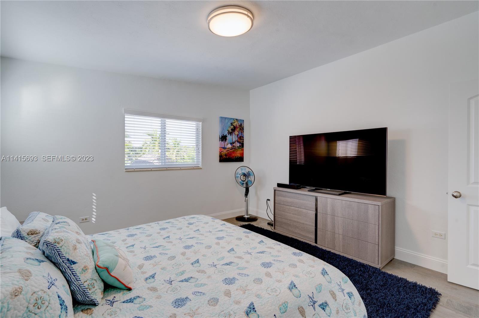 48 Andros Road Key Largo, FL 33037 - Photo 36 of 60 a bedroom with a bed and a flat screen tv