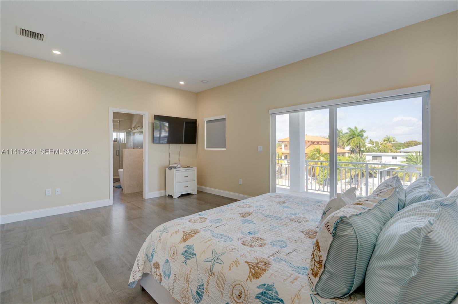 48 Andros Road Key Largo, FL 33037 - Photo 39 of 60 a bedroom with a bed and a large window