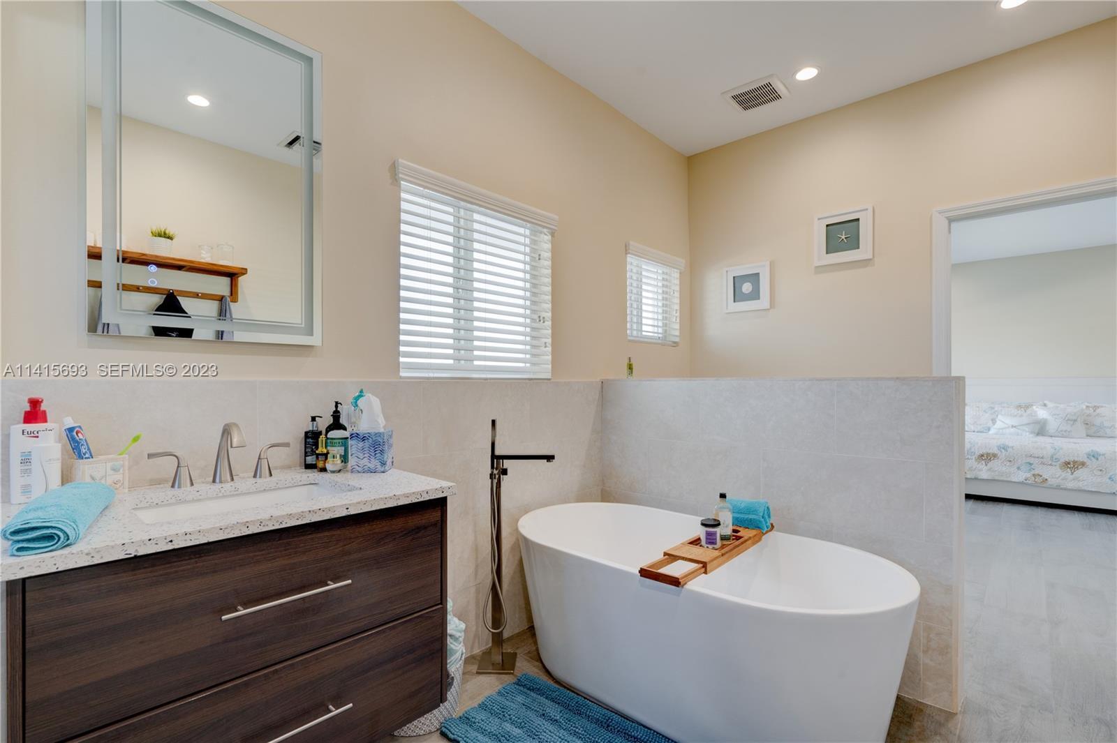 48 Andros Road Key Largo, FL 33037 - Photo 42 of 60 a white bath tub sitting in a bathroom