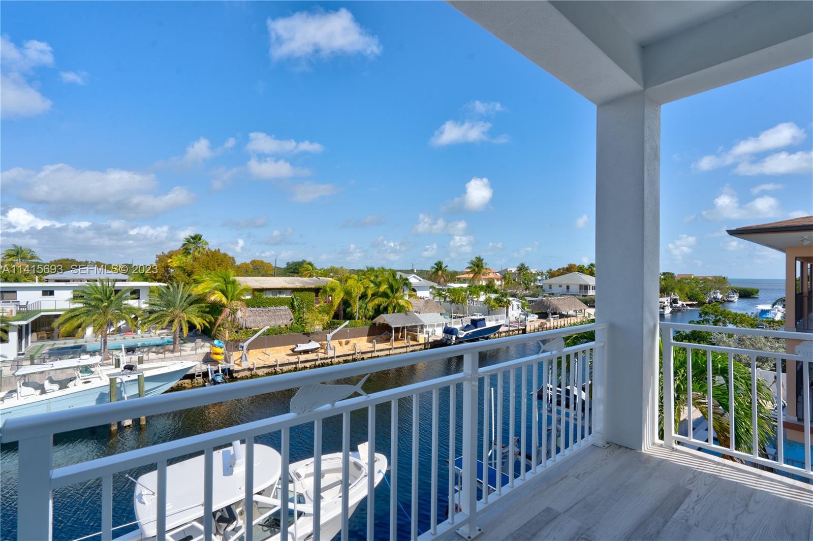 48 Andros Road Key Largo, FL 33037 - Photo 44 of 60 a view of a chairs and table in a balcony