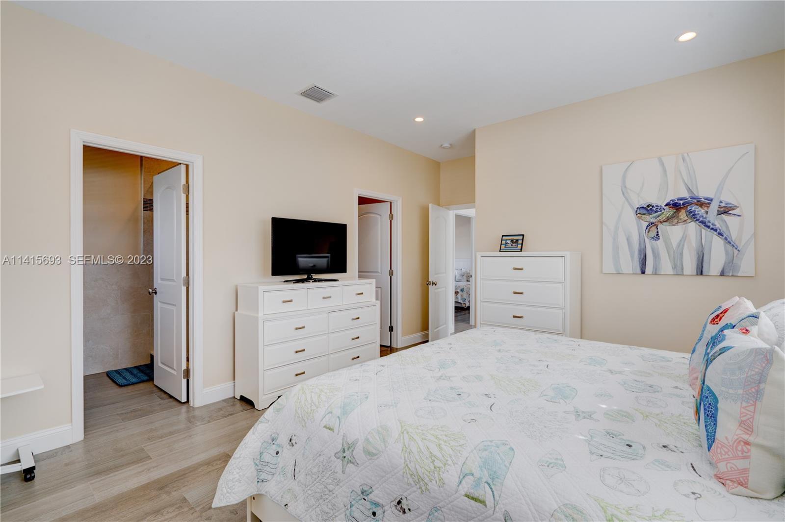 48 Andros Road Key Largo, FL 33037 - Photo 49 of 60 a bedroom with a bed and a flat screen tv