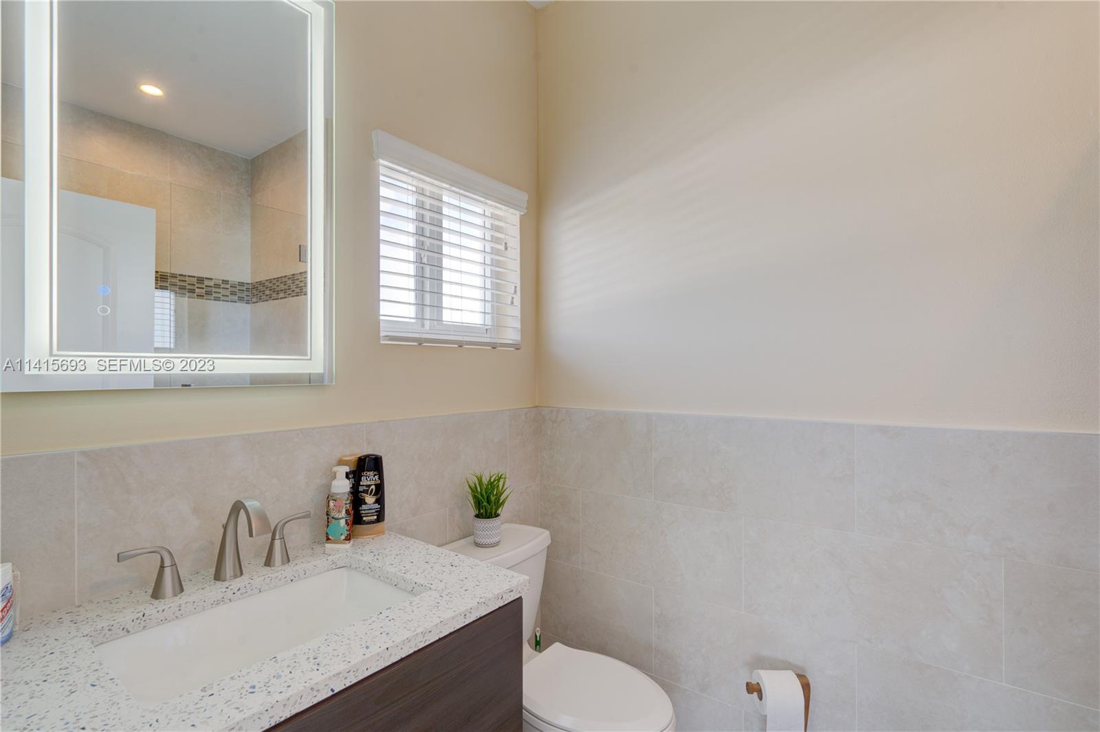 48 Andros Road Key Largo, FL 33037 - Photo 51 of 60 a bathroom with a sink toilet and a mirror