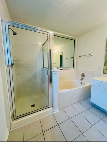 a bathroom with a bathtub and a shower