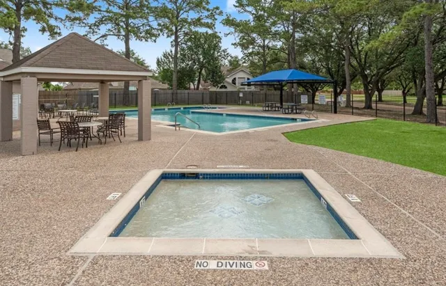 a view of a patio with a table and chairs under an umbrella