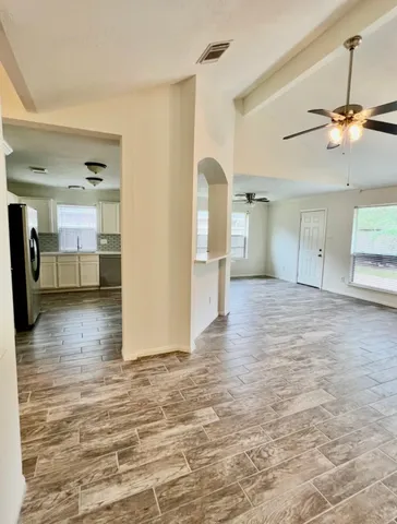 a view of a livingroom with furniture and a ceiling fan