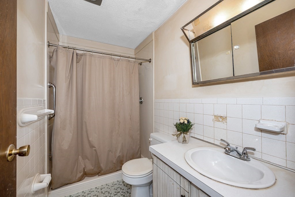 3 Summit Drive, Unit 16 Reading, MA 01867 - Photo 13 of 21 a bathroom with a sink toilet and shower