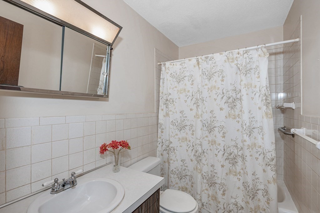 3 Summit Drive, Unit 16 Reading, MA 01867 - Photo 17 of 21 a bathroom with a sink and toilet