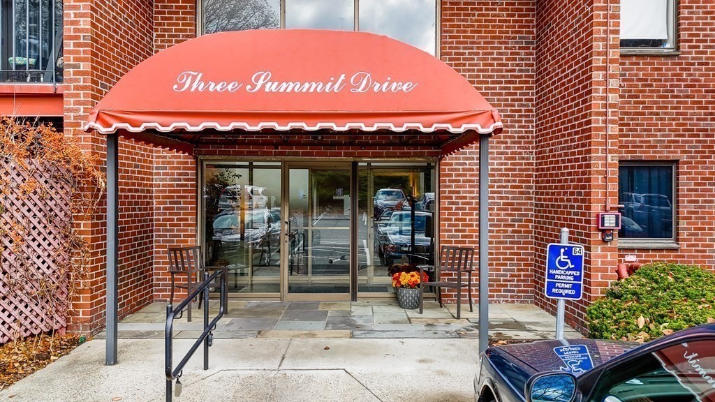 3 Summit Drive, Unit 16 Reading, MA 01867 - Photo 2 of 21 a sign on the wall of building