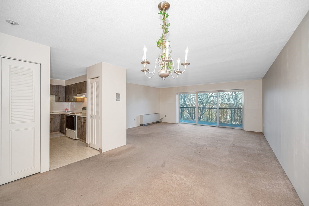 3 Summit Drive, Unit 16 Reading, MA 01867 - Photo 5 of 21 a view of an empty room with a window