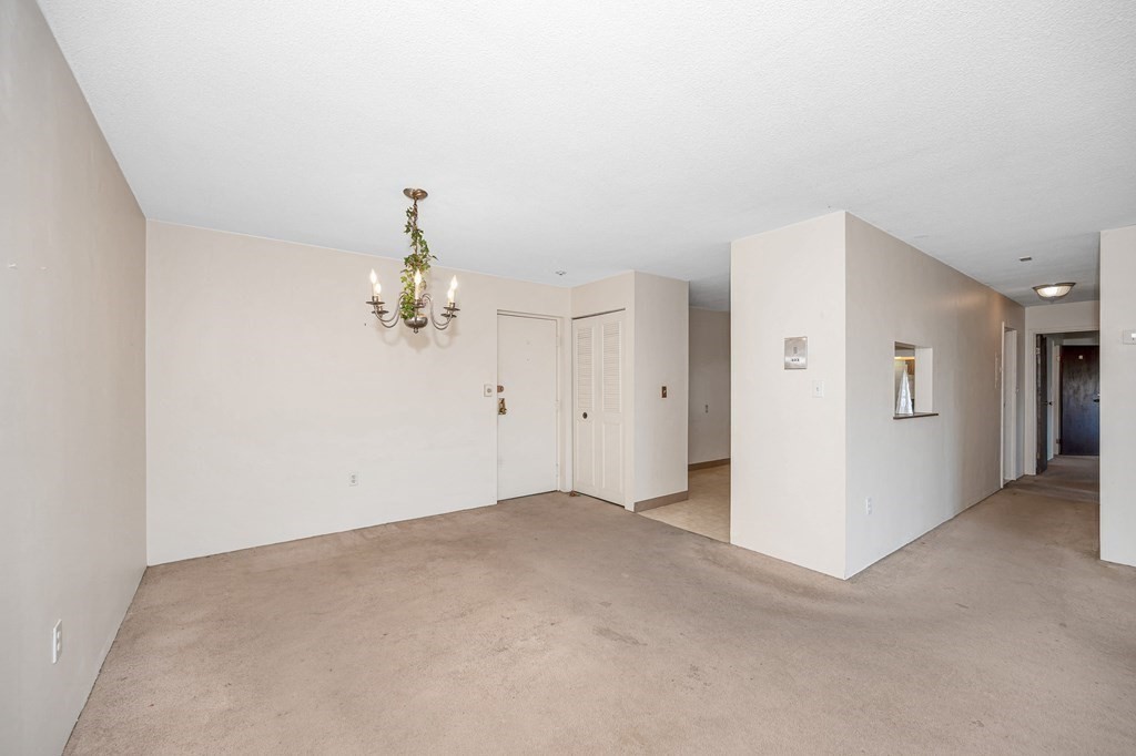 3 Summit Drive, Unit 16 Reading, MA 01867 - Photo 6 of 21 a view of a chandelier in an empty room