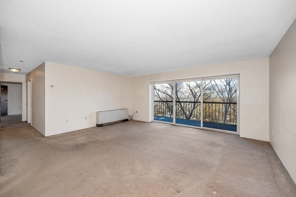 3 Summit Drive, Unit 16 Reading, MA 01867 - Photo 7 of 21 an empty room with windows