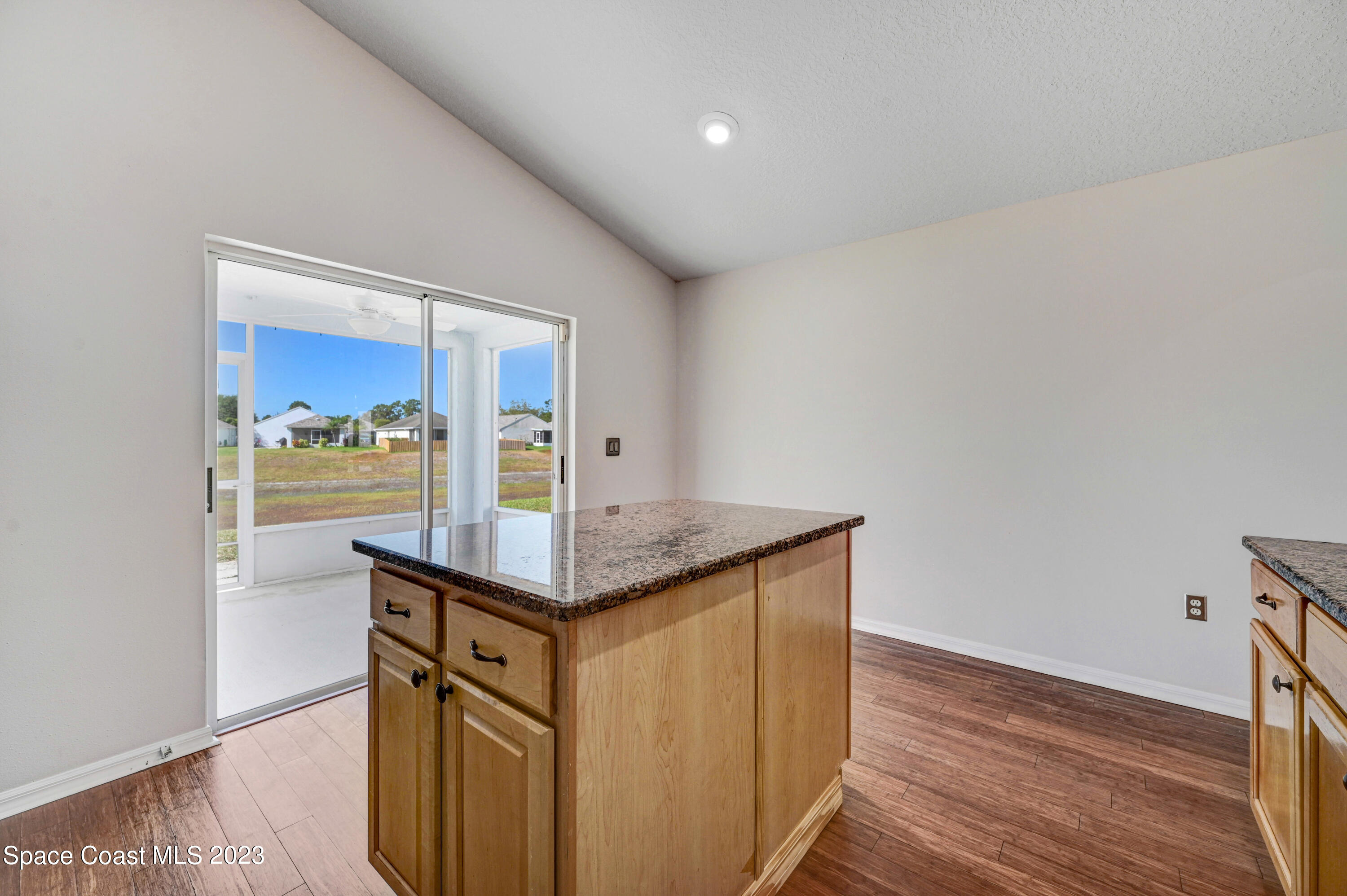 2070 Redwood Circle Palm Bay, FL 32905 - Photo 13 of 33 a kitchen with stainless steel appliances granite countertop a sink and wooden floor