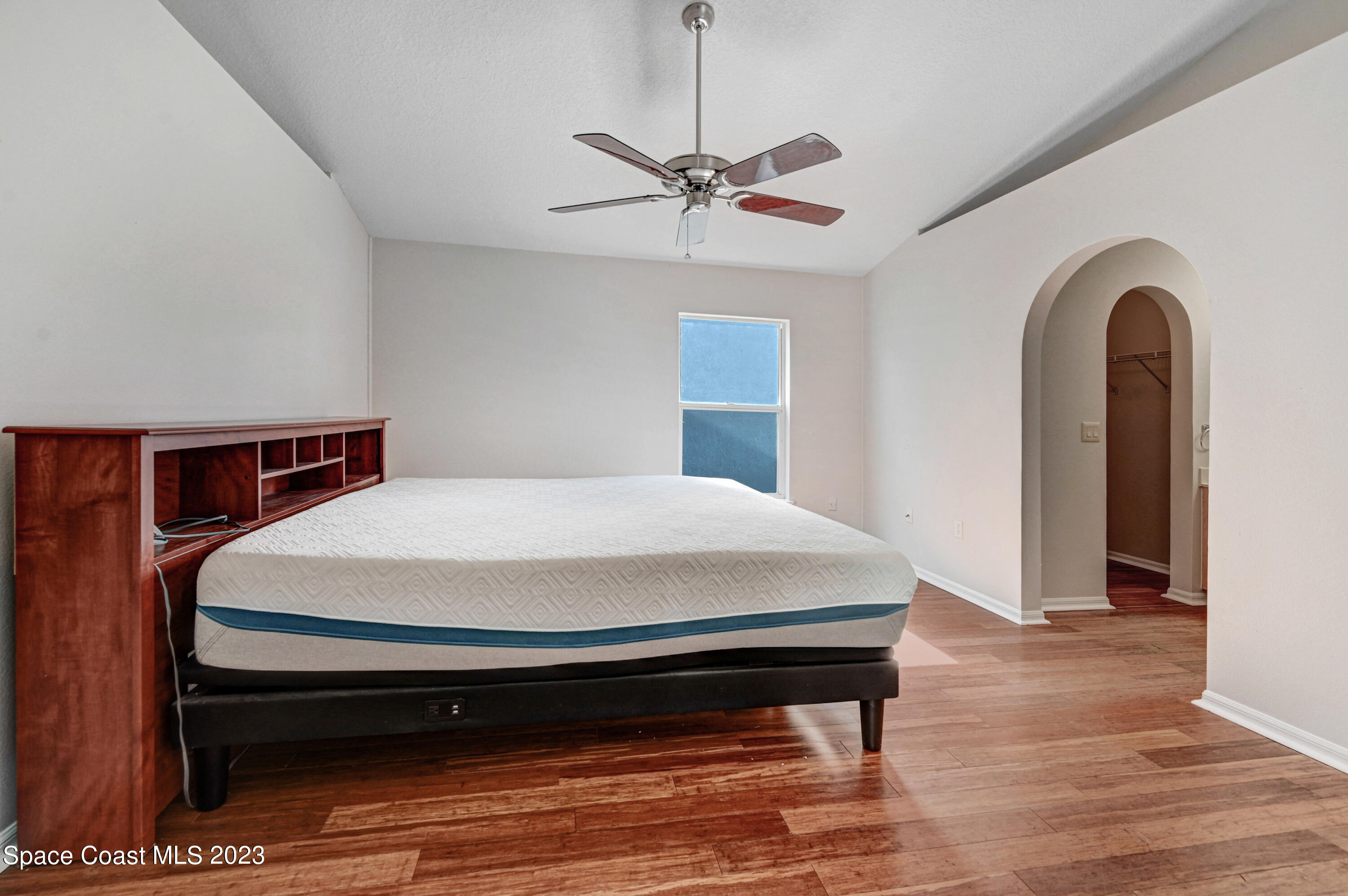 2070 Redwood Circle Palm Bay, FL 32905 - Photo 14 of 33 a bed sitting in a bedroom next to a window