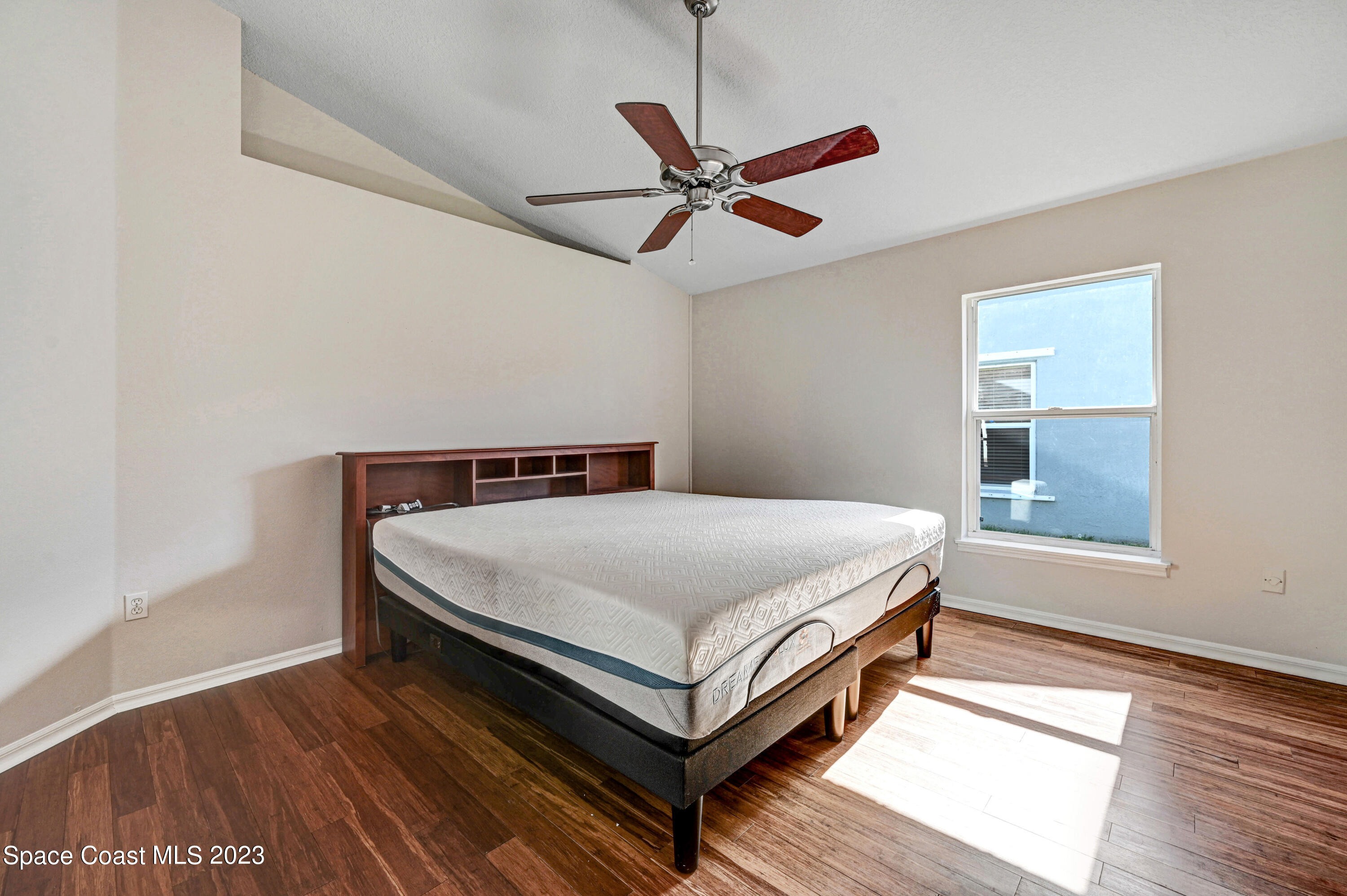 2070 Redwood Circle Palm Bay, FL 32905 - Photo 15 of 33 a bedroom with a bed and window